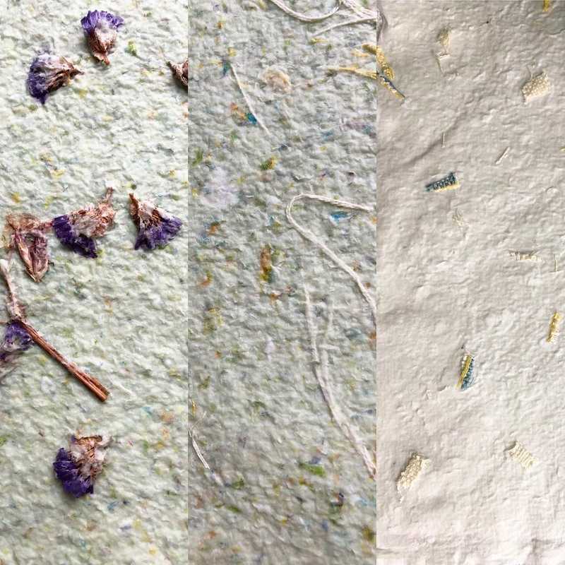 Three types of handmade paper, one with embedded flowers and the other two with fabric fibers.